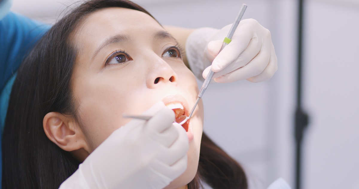Dentist examining a patient with a chipped tooth during an emergency dental visit